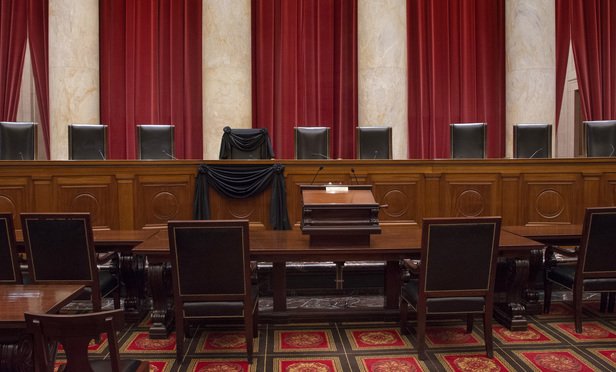 The Courtroom of the Supreme Court showing Associate Justice Antonin Scalia’s Bench Chair and the Bench in front of his seat draped in black following his death on February 13, 2016. Credit: Franz Jantzen/Collection of the Supreme Court of the United States.